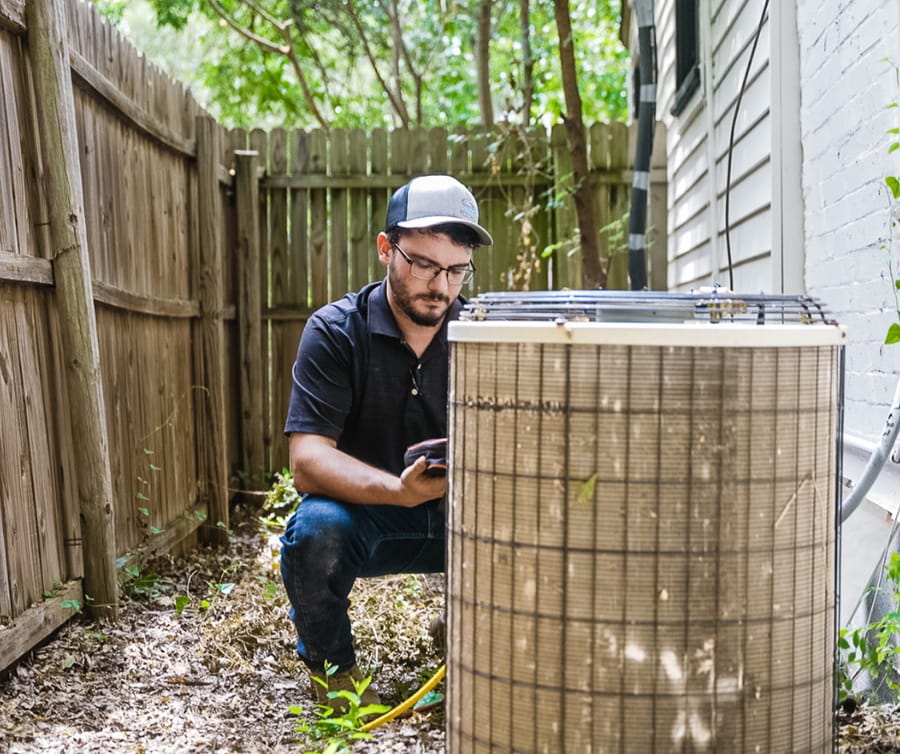 1st Choice employee working on an HVAC unit