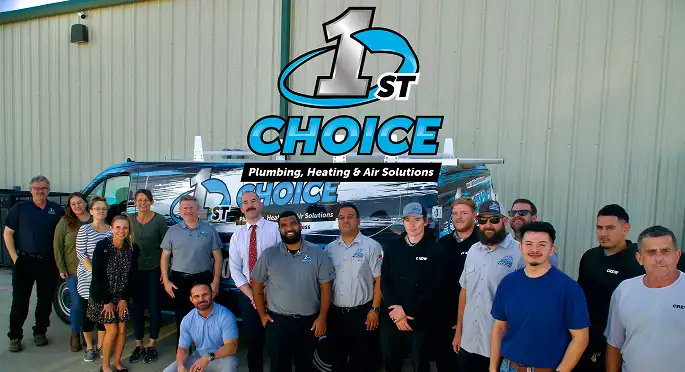 A group of fifteen 1st Choice Plumbing, Heating & Air Solutions employees standing in front of a company van.